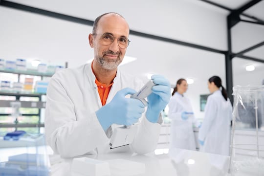 Male Scientist Looking at Camera while changing Settings on Eppendorf Xplorer_REG_ plus 24-channel Electronic Pipette