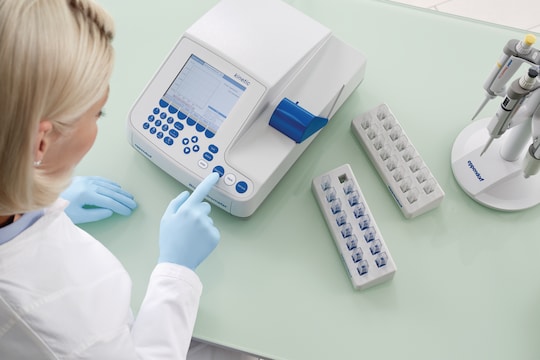 Scientist measures sample with cuvette in photometer from Eppendorf
