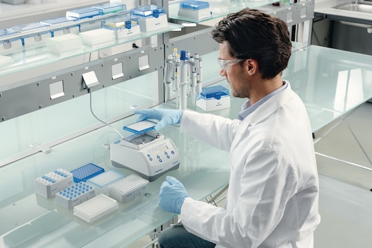 Scientist puts plate on Eppendorf MixMate to mix samples