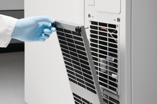 Scientist opening the filter compartment of the Eppendorf CryoCube® F101h ULT freezer