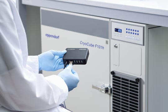 Scientist connects Eppendorf CryoCube® F101h ULT freezer with data transfer box