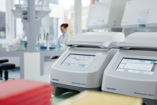 Noise reduction of the cycler by smart air channeling. Two Eppendorf Mastercycler X50h with touchscreen interface located at the bench of a laboratory.