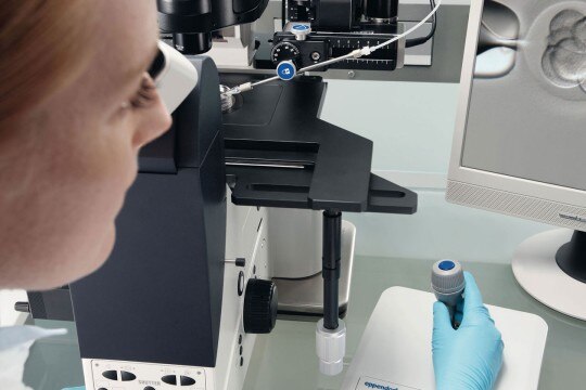 Ergonomic cell manipulation Female scientist in the laboratory handling comfortably a microscope’s joystick while use the DualSpeed function.