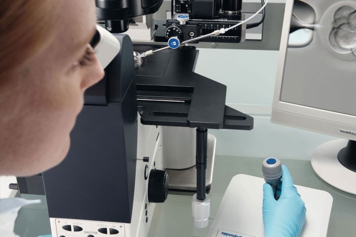 Ergonomic cell manipulation Female scientist in the laboratory handling comfortably a microscope’s joystick while use the DualSpeed function.