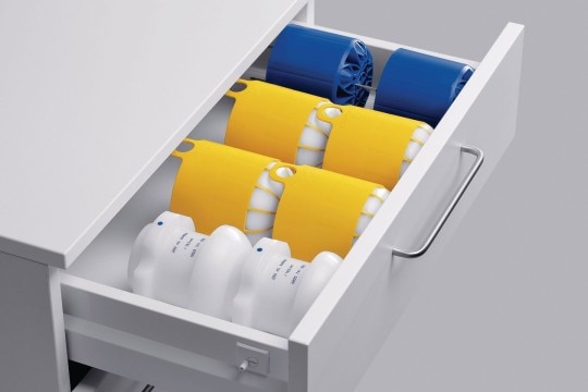 PhysioCare Concept® - Centrifuges Drawer full of centrifuge adapters in blue, yellow, and white.