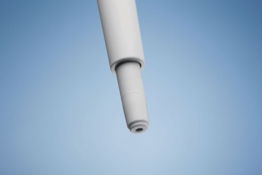 Comfortable handle for your pipette carousel. A tip cone of an Eppendorf pipette and blue background.