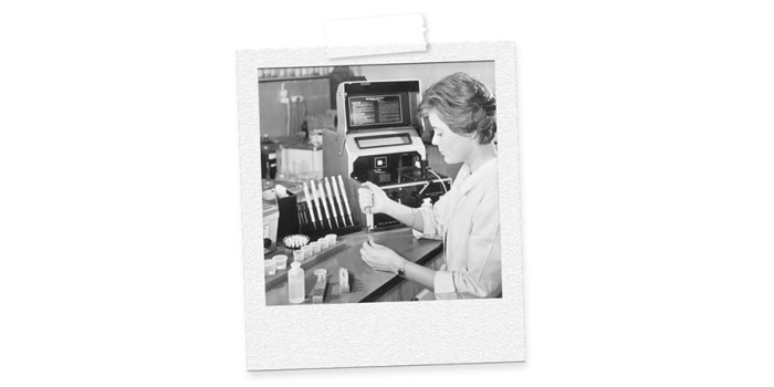 60yearstubes – scientists working in lab with microliter system Image of a woman, working in lab with tubes, pipette and centrifuge