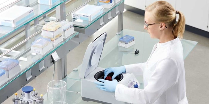 Eppendorf benchtop microcentrifuge, surrounded by Eppendorf pipettes and lab consumables