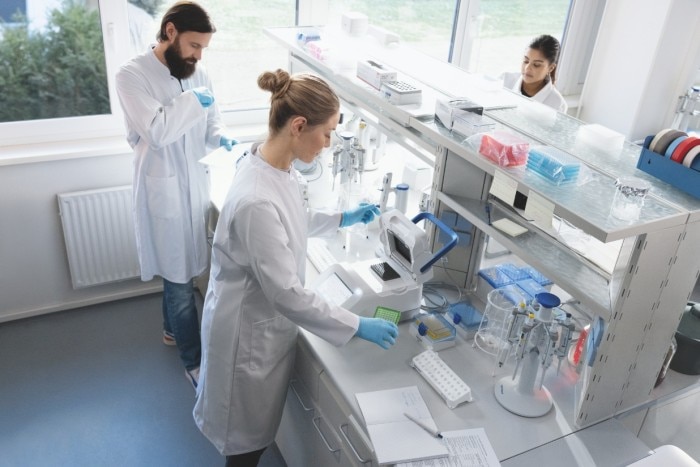 Team of scientists working in the lab, PCR plate about to enter the Mastercycler X40