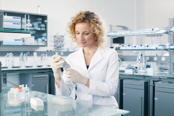 Female laboratory technician with Eppendorf Xplorer_REG_ / Xplorer plus electronic pipette in the lab