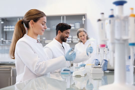 Team working on bench with Eppendorf Research® 3 neo single-channel pipettes
