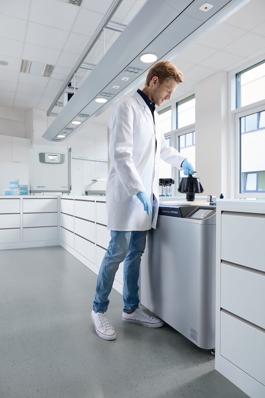 MAn inserting rotor in Centrifuge CP100NX