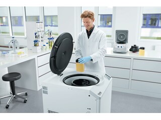 Man loading 1.5 L bottles into Centrifuge CR30NX