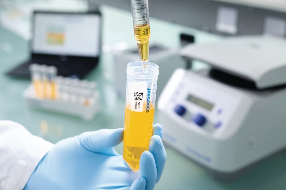 Eppendorf SafeCode conical tubes in hand Scientist transfers sample liquid into barcoded conical tube by using a pipet helper