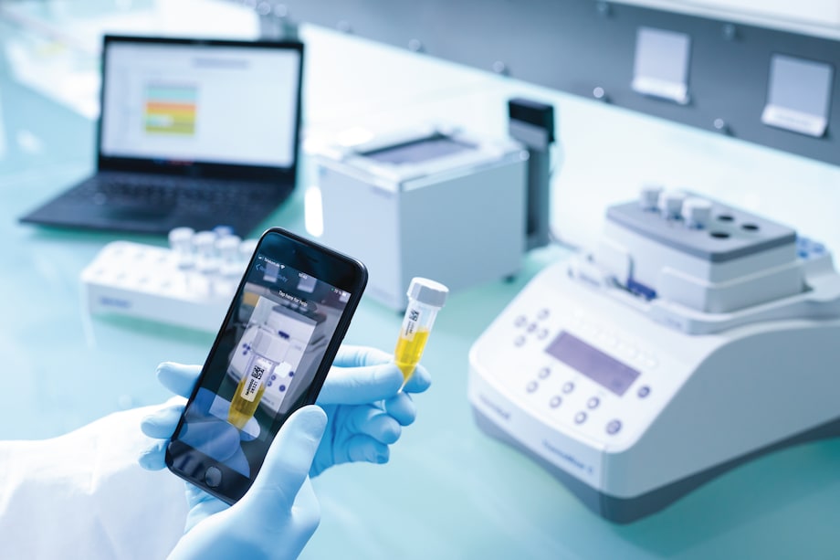 Eppendorf SafeCode 5 mL conical tube in hand while scanning 5 mL conical tubes with Eppendorf SafeCode barcode label to ensure safe sample identification in hand of scientist and scanned by mobile phone