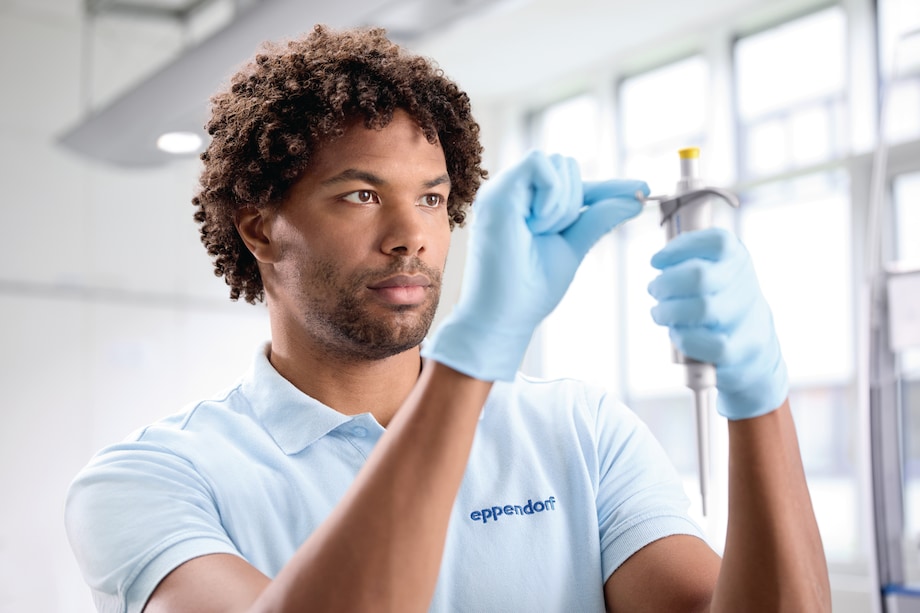 Research plus_Technician adjusting pipette