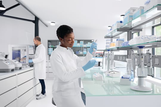 Female scientist using Eppendorf Xplorer® plus electronic pipette to fill an Eppendorf Tube®