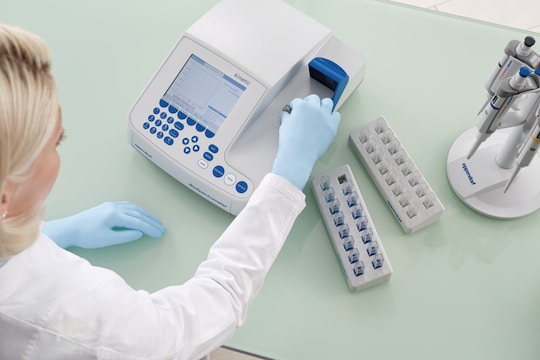 Scientist putting cuvette into photometer from Eppendorf