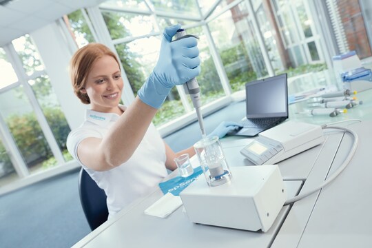 Eppendorf service technician measuring a pipette using a high-precision single-channel balance