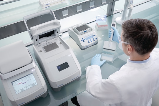 Man using Eppendorf Xplorer® plus 24-channel pipette to fill a 384-well plate