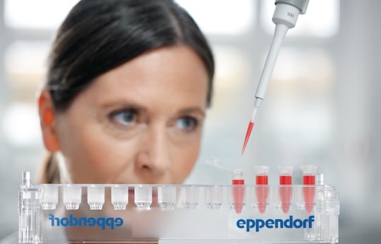 Lab worker pipetting sample into microtubes