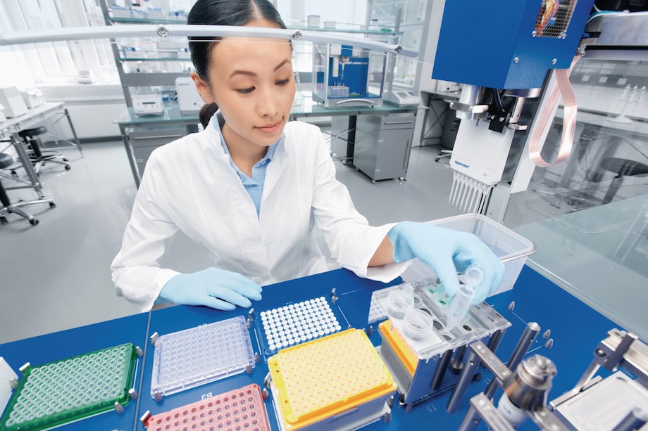 Lab tech infront epMotion with 5 mL tube, view from top Many different consumables can be handled in the epMotion liquid handling robots
