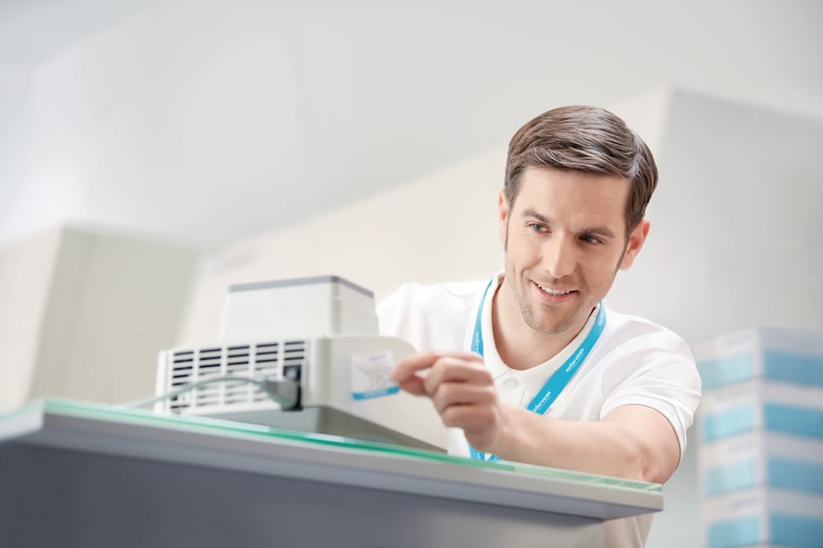 Image – Eppendorf ThermoMixer® Man in lab applying sticker on Eppendorf ThermoMixer®