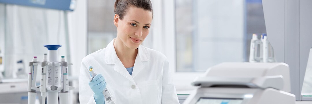 Mastercycler X50 Femal laboratory assistant with pipette in her hand and Mastercycler X50 in the foreground