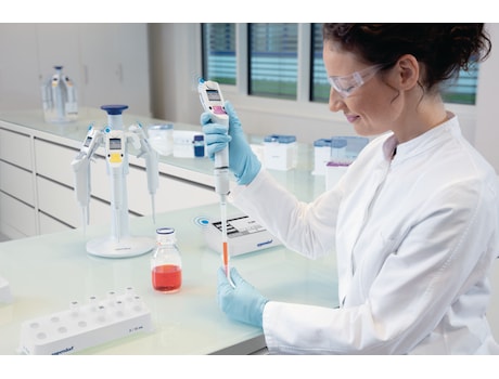 Female scientist pipetting with an Eppendorf Xplorer<sup>&reg;</sup> connected electronic pipette managed via the Pipette Manager system